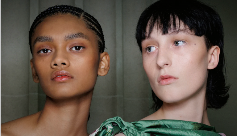 Close-up portrait of two models with fresh, natural looks — a visual highlight from Fashionista’s November beauty picks.
