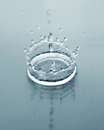 A water droplet creating a splash ripple — symbolizing the refreshing and balancing role of toner in a skincare routine.
