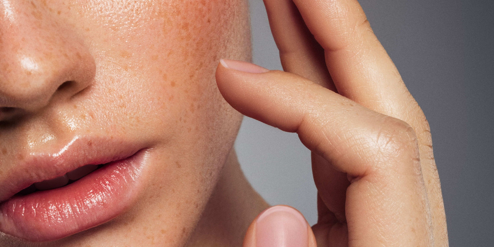 A close-up of skin being gently touched — visually illustrating the sensitivity and scrutiny surrounding topical exosome safety in skincare.