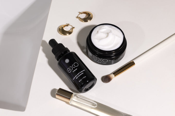 A luxury flat lay featuring Exoceuticals® EXO PLUS Anti-Aging Cream and serum — visually supporting the product’s dual-action positioning in editorial skincare features.