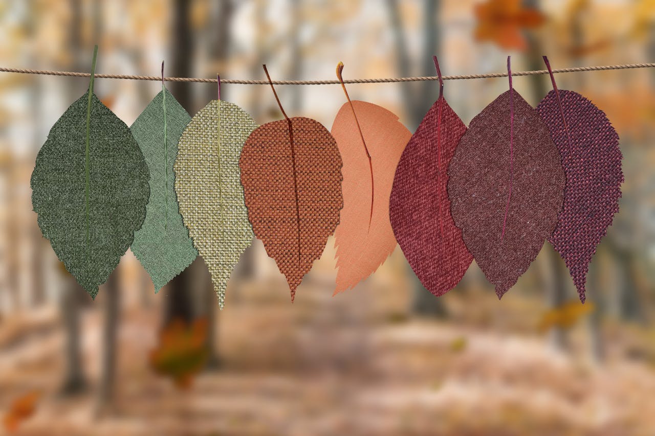 A row of colorful fabric leaves representing seasonal change — visually supporting the need to adapt skincare routines throughout the year.